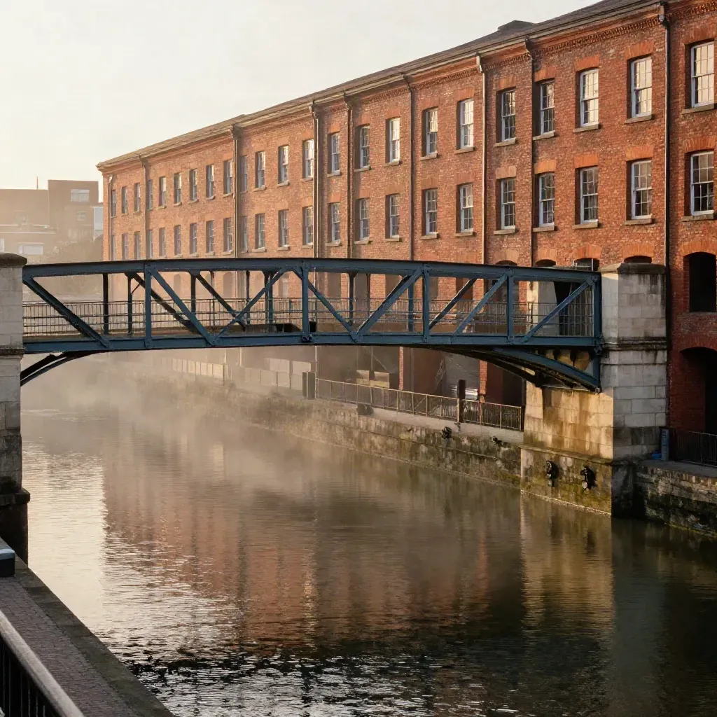 Birmingham canal bridges and red-brick warehouses above calm misty water